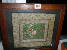A framed and glazed early 20th century embroidered panel.