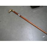 A three piece walking stick with brass horse head handle.