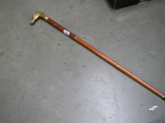 A three piece walking stick with brass horse head handle.