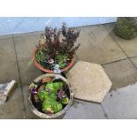 Two stone planters and a hexagonal paving stone