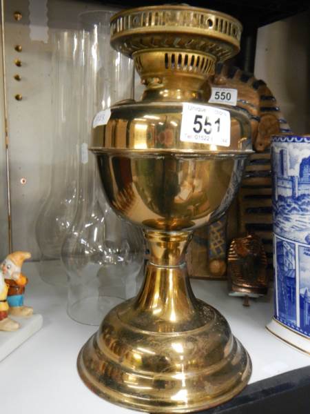 A brass oil lamp base and two glass chimneys.