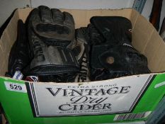 A box of mainly motor cycle gloves.