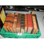 A box of antique leather bound books.