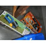 A boxed battery powered grass cutter and a boxed DT750 blow lamp.