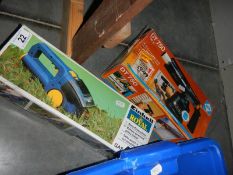 A boxed battery powered grass cutter and a boxed DT750 blow lamp.