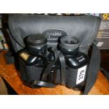 A cased pair of Halina binoculars.