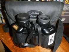 A cased pair of Halina binoculars.