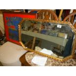 A gilt framed bevel edged mirror and an advertising mirror a/f. Approximately 72cm x 44cm