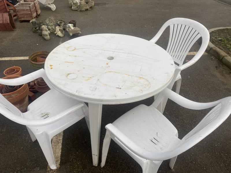 A plastic garden set including table and 3 chairs