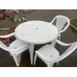 A plastic garden set including table and 3 chairs