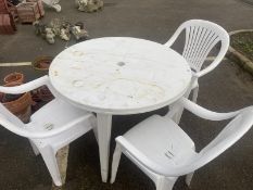 A plastic garden set including table and 3 chairs