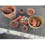 A quantity of terracotta plant pots and other items