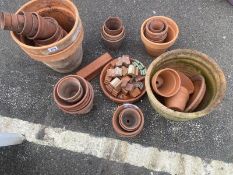 A quantity of terracotta plant pots and other items
