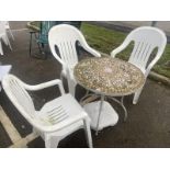 3 plastic garden chairs and a mosaic tile top table