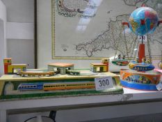 Two tin plate toys - Orbital train and fairground ride.