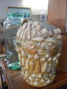 An E C Davies, Gainsborough 1 gall stoneware flagon decorated with shells and a lidded glass jar.