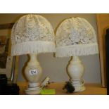 A pair of heavy table lamps with shades.