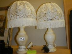 A pair of heavy table lamps with shades.