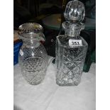 A square cut glass decanter and a double spout decanter.