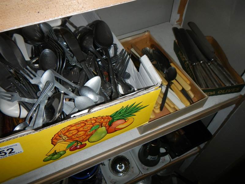 Three trays of cutlery.