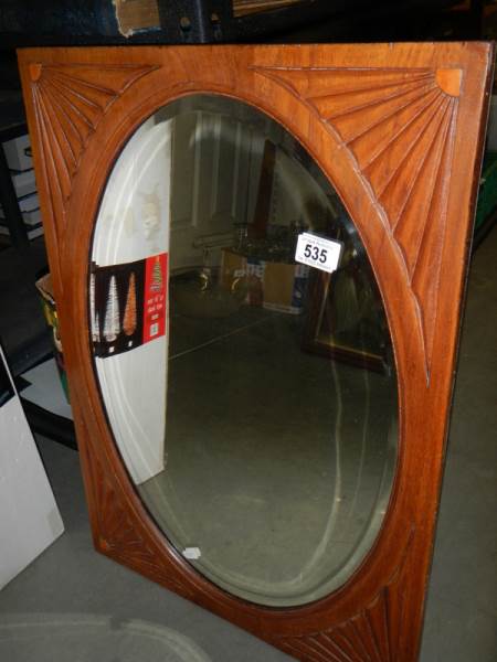 A circa 1920's mahogany framed oval bevel edged mirror, COLLECT ONLY.