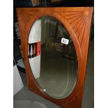 A circa 1920's mahogany framed oval bevel edged mirror, COLLECT ONLY.