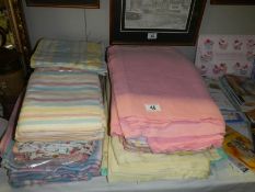 A quantity of flannelette sheets and pillow cases plus some cotton sheets.