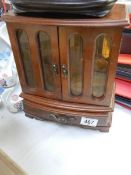 A two door jewellery cabinet containing costume jewellery.