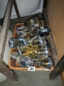 A tray of plastic silver coloured goblets.