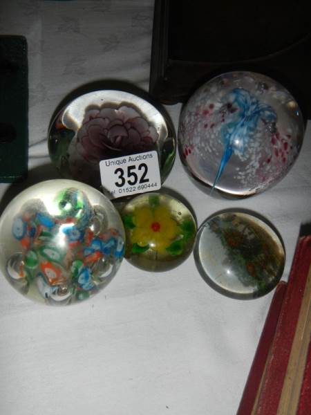 A collection of paperweights.