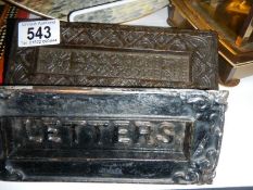 Two cast iron letter boxes.