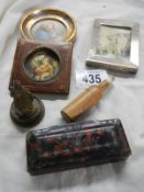 A silver photo frame, two miniatures and a snuff box.