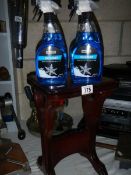 A mahogany side table and four bottles of cleaner.