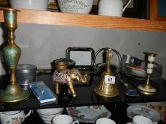 A mixed lot of metalware including brass bell, elephant, candlestick etc.,