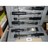 A cased set of new chisels.