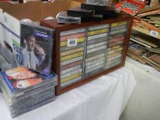 A cabinet of cassettes plus story and comedy tapes.