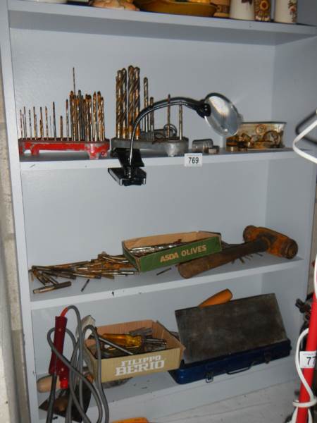 Three shelves of old tools.