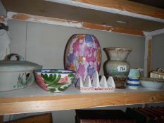 A shelf of miscellaneous ceramics.