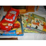 A quantity of children's books and a toy car.