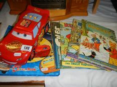 A quantity of children's books and a toy car.