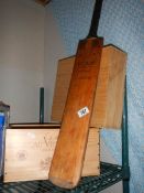 Two wooden boxes and a cricket bat.