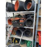 A large quantity of plastic flower pots and a shelf of hose reels and accessories