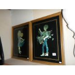 A pair of framed and glazed silver foil pictures.