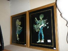 A pair of framed and glazed silver foil pictures.