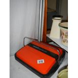 A Bissell carpet sweeper.