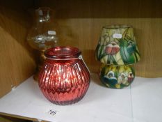 A Tiffany style painted glass tea lamp and two others.