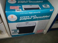 A boxed cross cut paper shredder in working order.