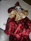 A clown doll with ceramic head.