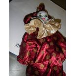 A clown doll with ceramic head.