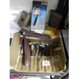 A mixed lot including tool roll with contents, boxed magnifying glass etc.,